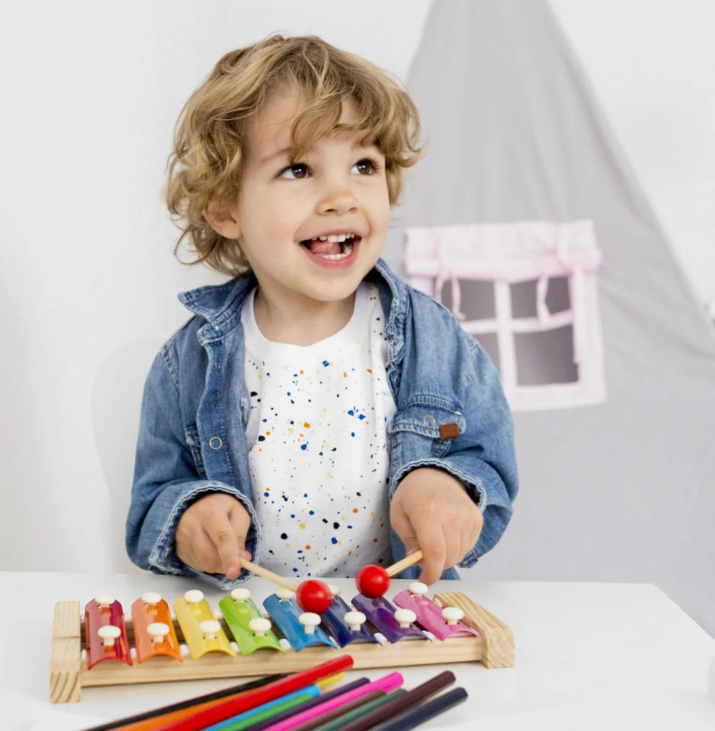 front view boy playing with xylophone | English Explorers